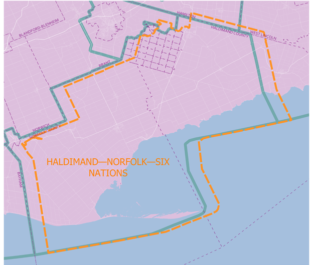 A map with an irregular shaped orange border around the title: Haldimand – Norfolk – Six Nations. A blue border, labeled Electoral Boundary Commission Proposal, somewhat duplicates the other border although offset.